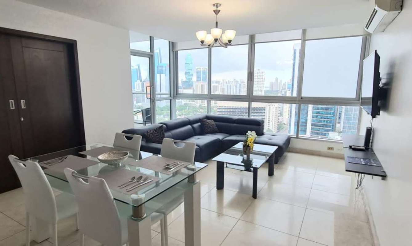 Master bedroom with large windows offering ocean and skyline views in PH Villa del Mar