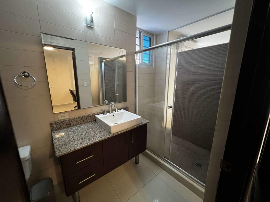 Outdoor communal bar lounge with seating overlooking Panama City at PH Vitro Loft