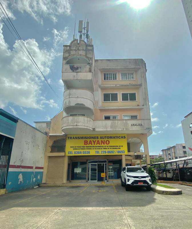 Multi-story PH Analisa building exterior with signage and parking Panama City