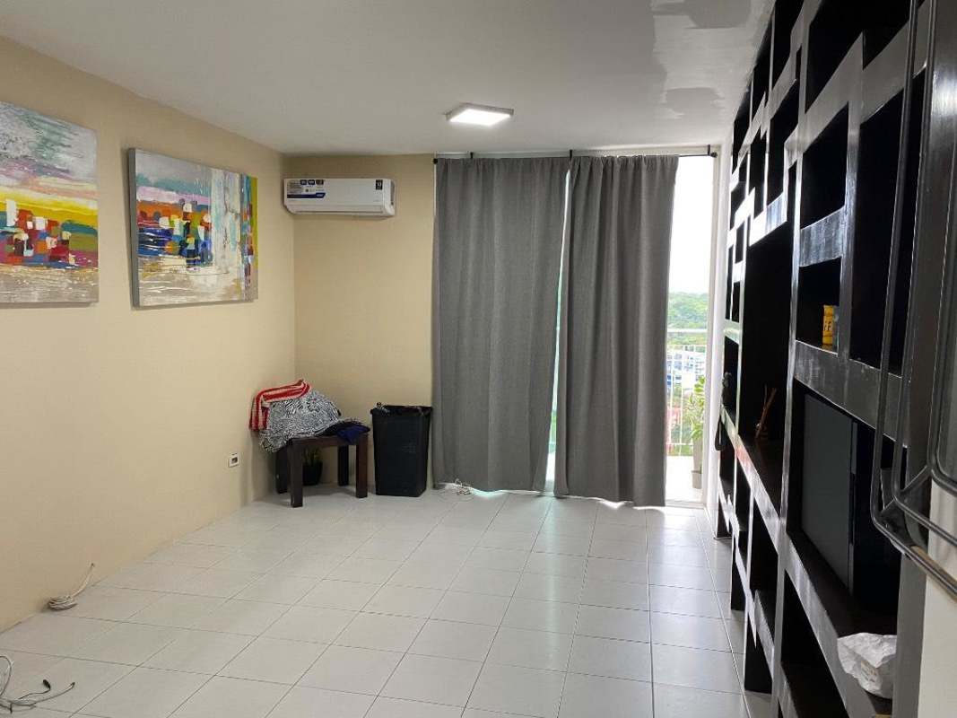 Spacious modern living room with large shelving unit, AC, window in Edison Park Panama City