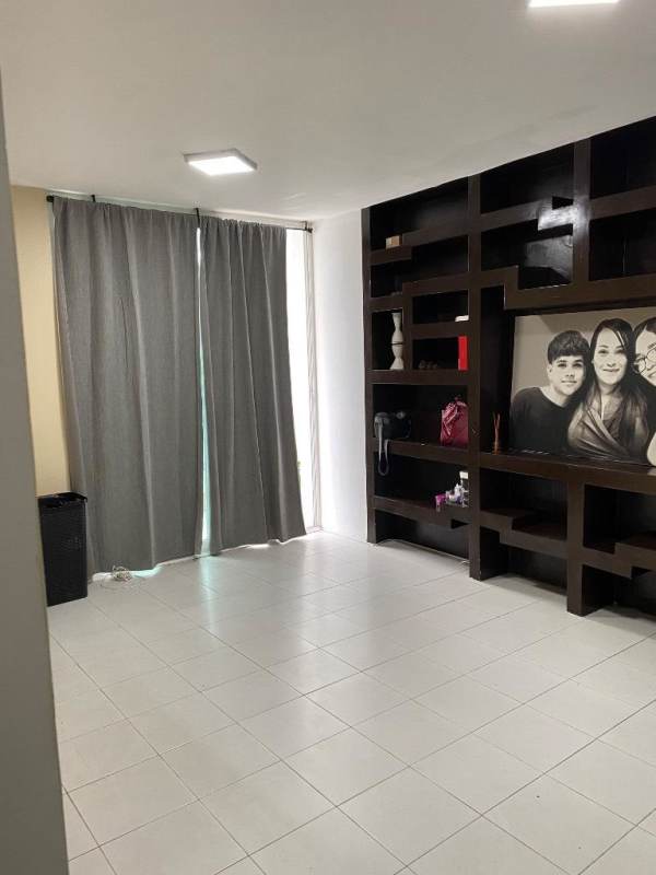 Modern minimalist living room with tile flooring and window in Edison Park apartment Panama City