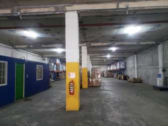 Interior warehouse with yellow pillars and platform loading area Free Trade Zone Panama