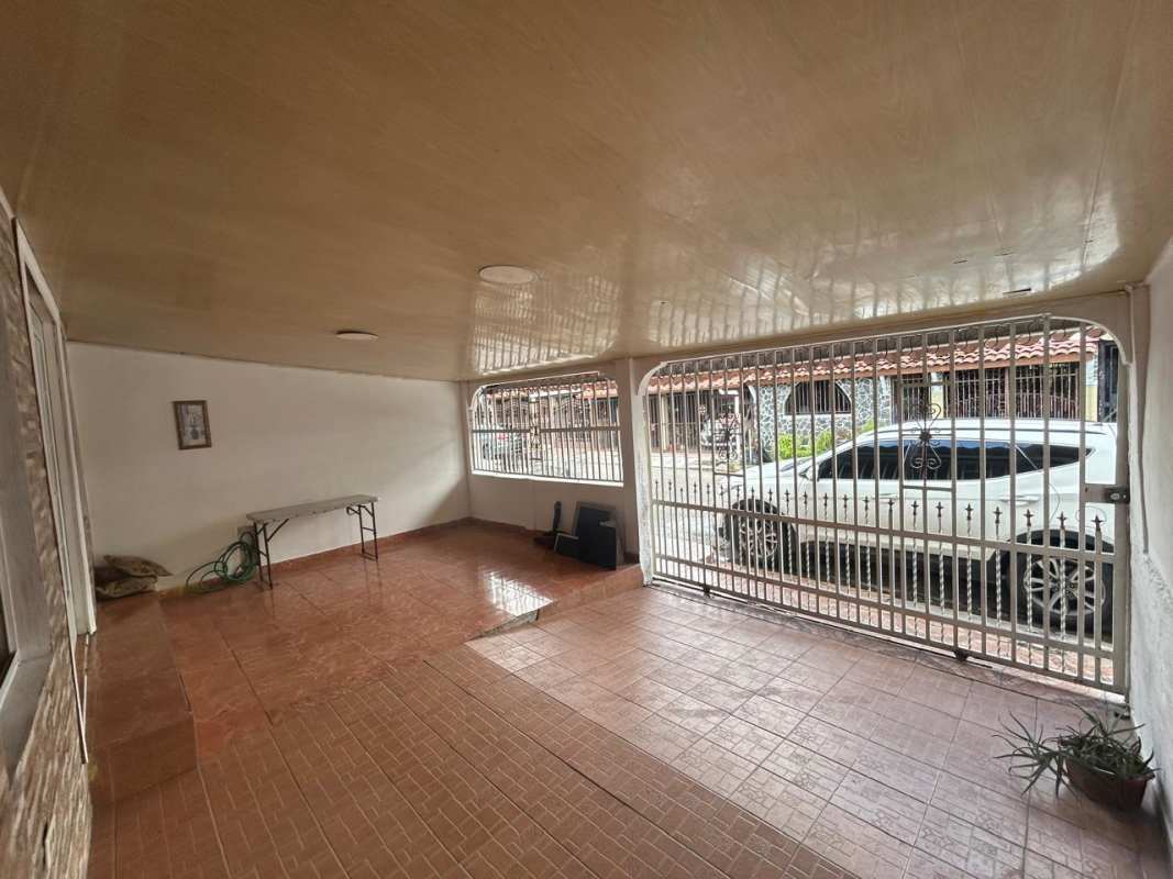 Minimalist bedroom with split AC, closet space, textured wall and window in Panama City house