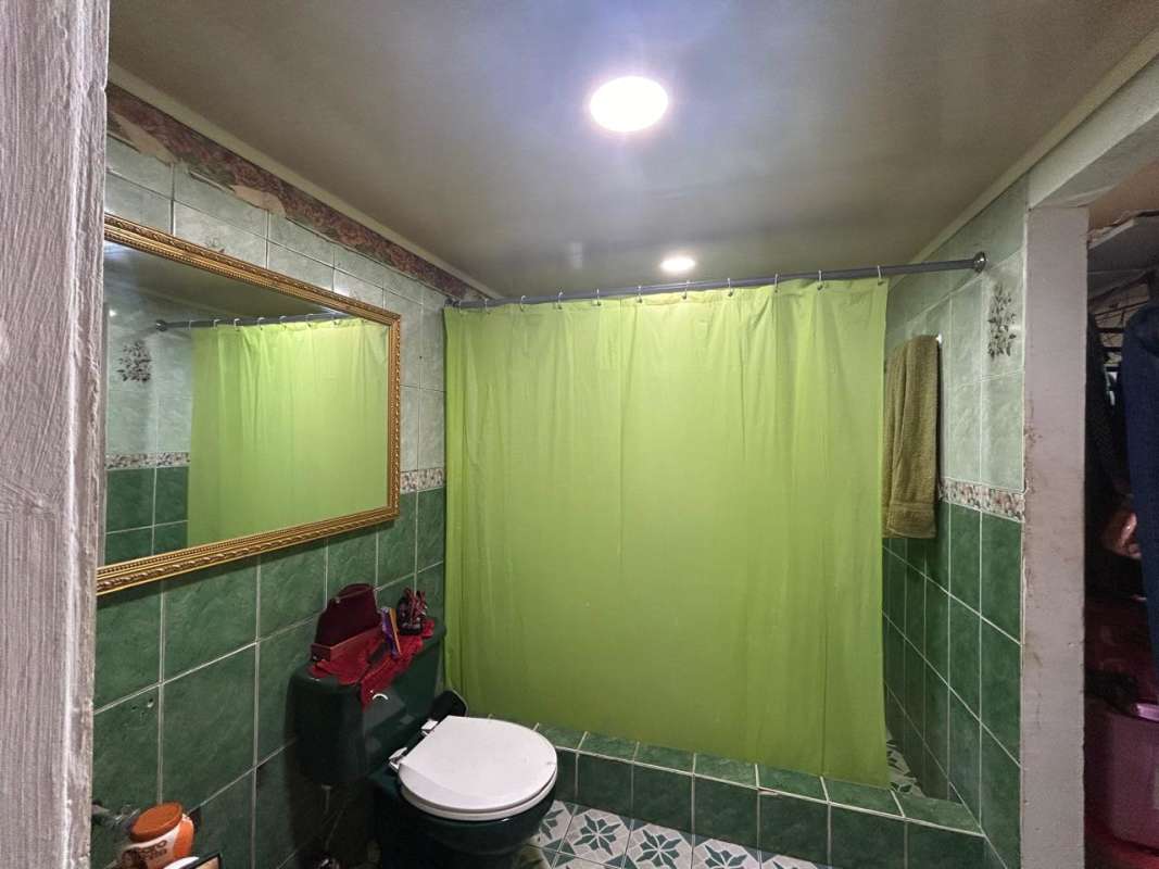 Open concept living dining with French doors, mirror and colorful decor in house Don Bosco Panama