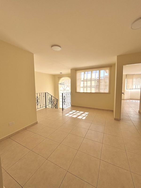 Covered terrace with columns, ceiling fan and view of garden in Senderos de Clayton home