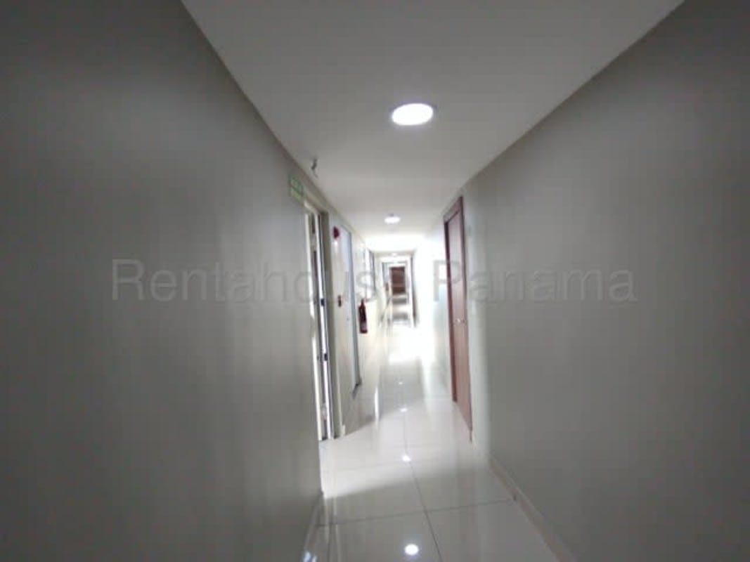 Compact kitchen with granite countertops and wood cabinetry Panama City apartment sale