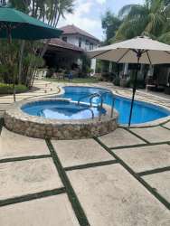 Luxury pool with jacuzzi surrounded by tropical gardens in Chumico Beach Panama
