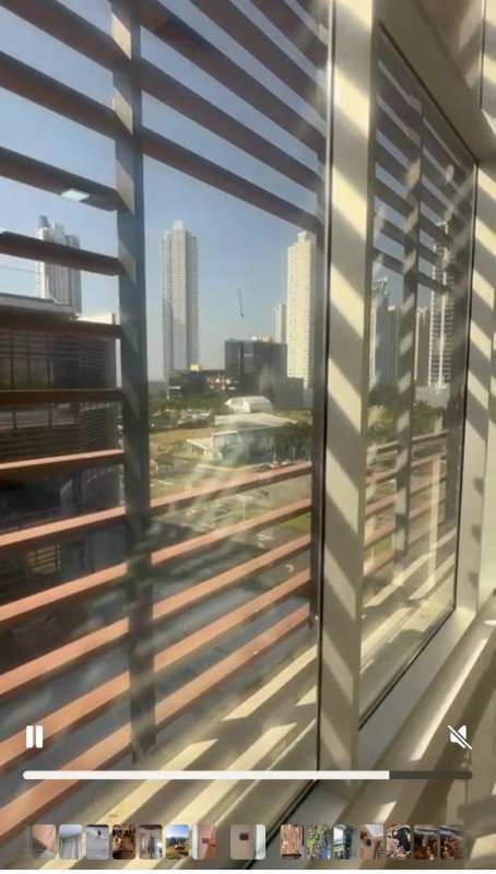 Large windows with horizontal blinds overlooking Panama City skyline from Town Center Costa del Este