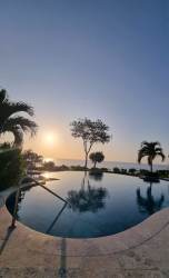 Moonlit poolside building with palm trees La Ensenada Resort San Carlos Panama