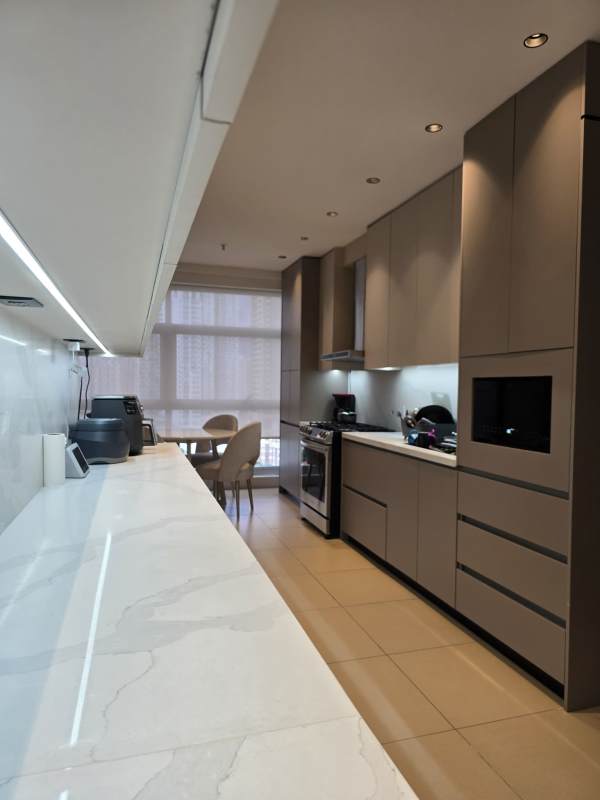 Marble countertop kitchen with large window and dining Q Tower Punta Pacifica Panama luxury apartment