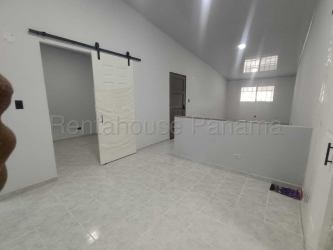Bright hallway with ceramic tile floor and barn-style door Villas de Arraijan Panama