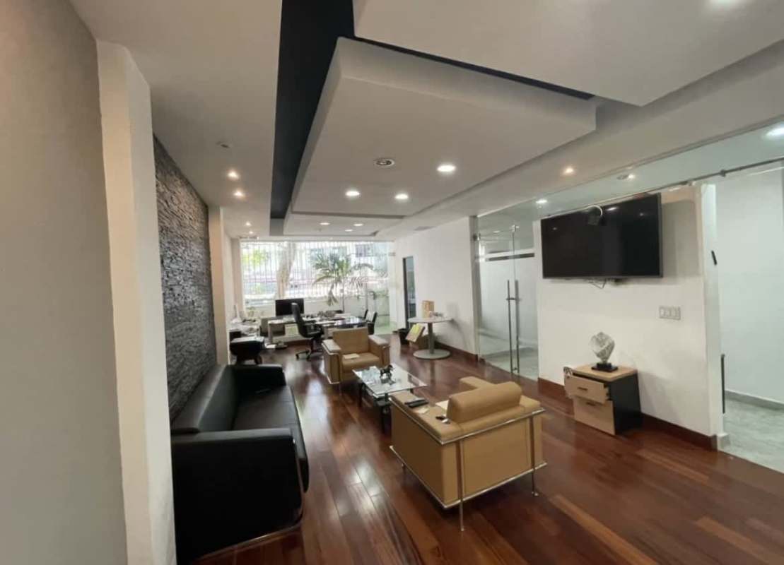 Modern meeting room with stone wall and conference table renovated in Obarrio Via España Panama