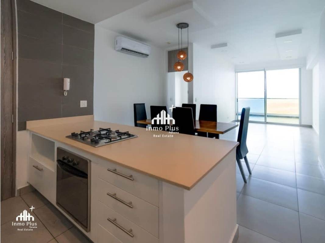 Open living and dining area with balcony and ocean views in Element Tower Panama City
