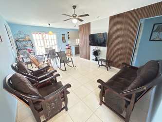 Bright living and dining space with tile floors in affordable house La Chorrera Panama
