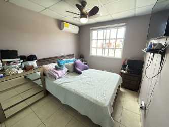 Bright bedroom with window, tiled floor in Panama house sale Las Arboledas