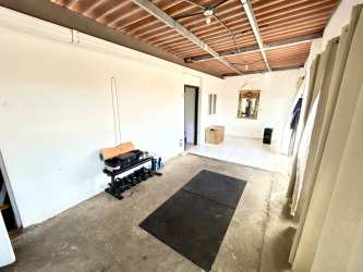 Kitchen with modern cabinetry, tile backsplash in La Chorrera home for sale