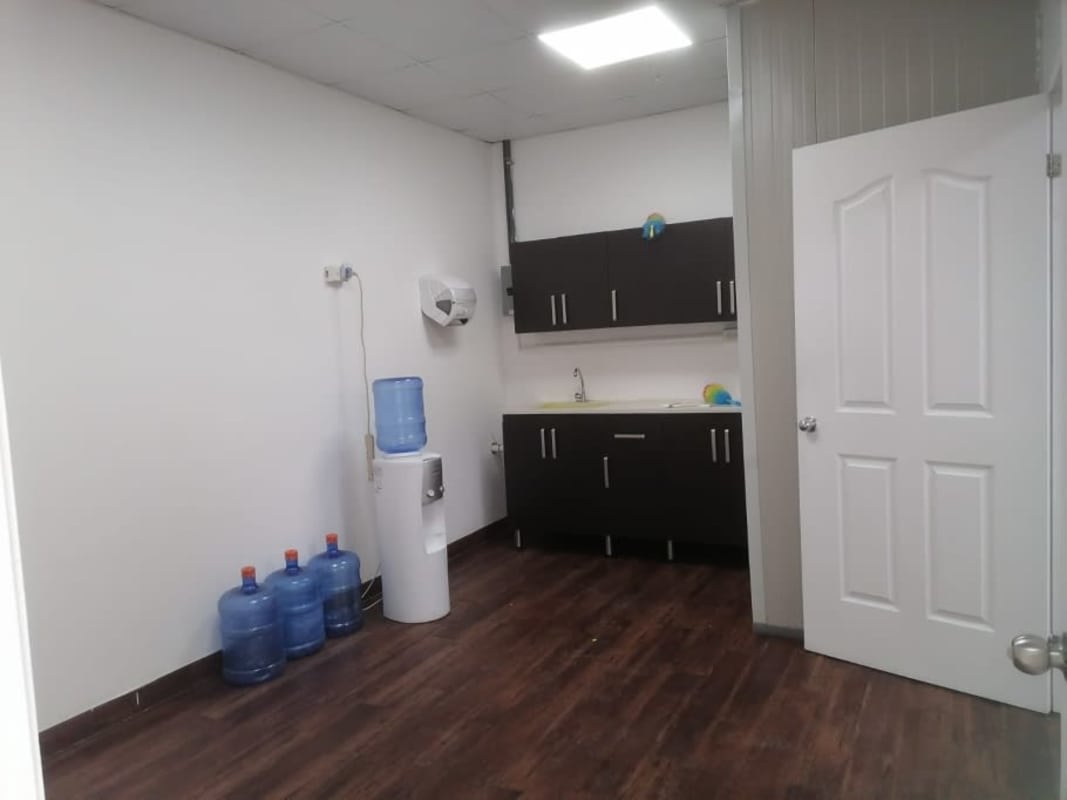 Interior warehouse storage industrial Panama with secure chain link fenced area and fire sprinklers