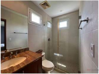 Private screened swimming pool with wooden deck and garden at Tucán Country Club residence Panama