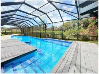 Living room with large windows, high ceilings, natural light, open design in luxury villa Panama