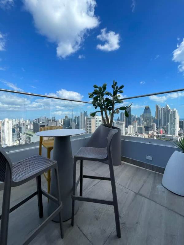 Elegant living room with artistic lighting and city-facing balcony PH Van Gogh El Cangrejo Panama City