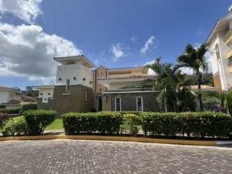 Luxurious living room with vaulted ceilings, natural light in Tucan Country Club villa