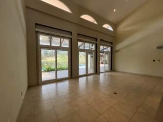 Elegant kitchen with granite countertops, dark cabinetry stainless appliances at Tucan Country Club Villa Panama