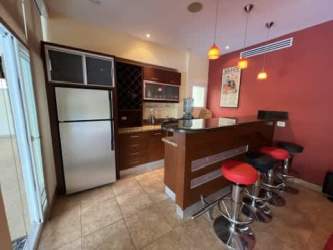 Spacious bedroom with en-suite bath and balcony access in Tucan Country Club luxury home Panama