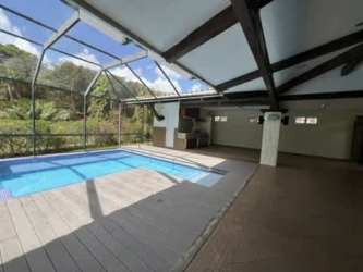 Covered indoor pool with BBQ and lounge area luxury villa Tucan Country Club Panama