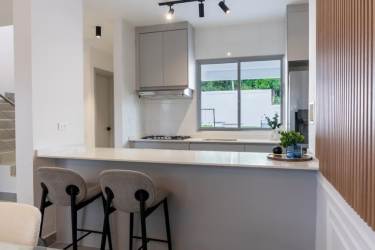 Modern kitchen with gray cabinets granite countertop stainless appliances Villas de Valencia Arraiján Panama