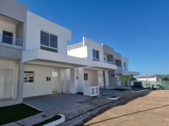 Bright living room with blue accent wall modern furnishings Villas de Valencia Arraiján