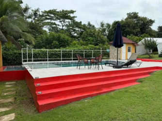 Bedroom with sliding door to patio, wood ceiling, ceiling fan in Panama lake retreat Capira