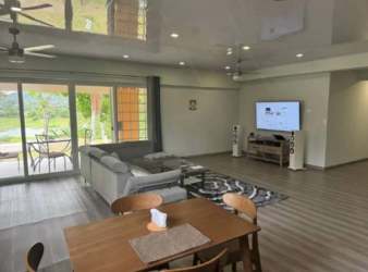 Outdoor swimming pool illuminated at night with seating area at San Juan Capira estate Panama