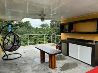 Furnished covered porch with seating at lakefront residence San Juan Capira Panama
