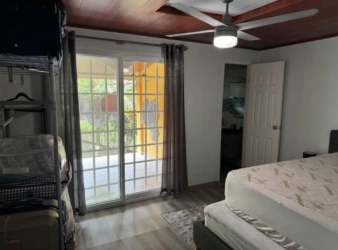 Elevated pool with red steps and outdoor dining surrounded by nature in San Juan Capira Panama