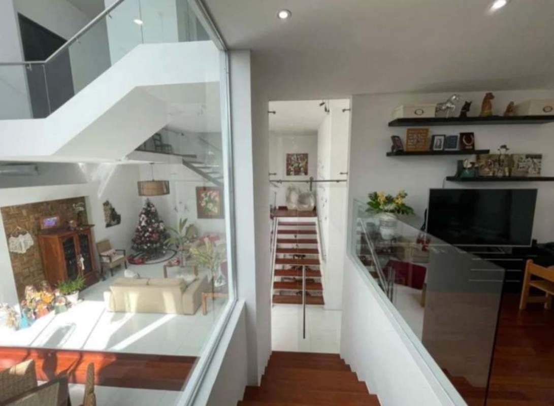 Multi-level living with glass railings, stairwell, modern decor Christmas tree Panama City upscale house rental