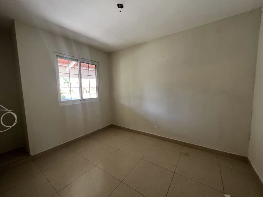 Large bright living room with tile floors, sliding glass doors to patio in PH Reserva de Versalles Juan Díaz Panama