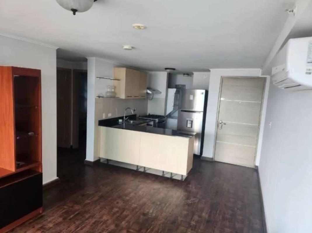 Kitchen with granite countertop, modern cabinetry, refrigerator, microwave in PH San Francisco Bay Panama City