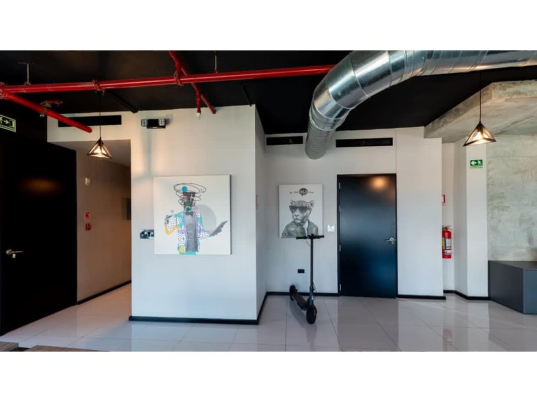 Spacious office entrance with exposed duct ceiling and modern industrial decor at PH BICSA Tower