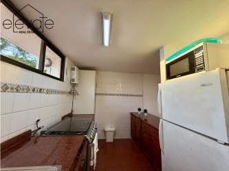 Bright kitchen traditional design double sink stove in duplex APPRUC Coronado beach house