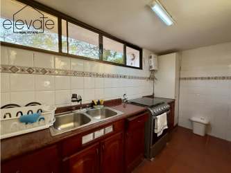 Covered patio terrace with terracotta tiles at APPRUC Coronado duplex near the beach
