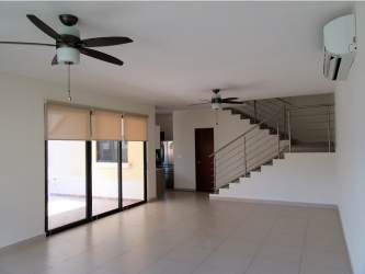 Spacious living room with ceiling fans and sliding doors to terrace in River Valley Panama Pacifico