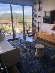 Living room with large windows and balcony access in apartment PH Centriqo Panama Pacifico