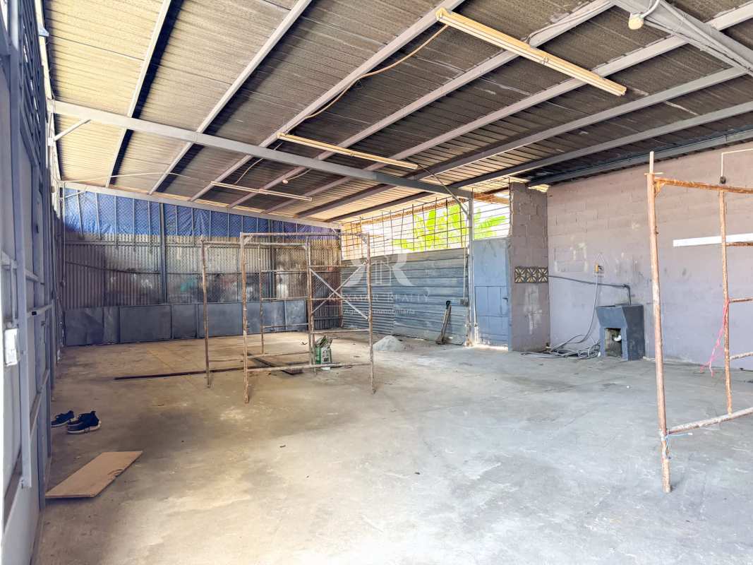 Empty open warehouse storage space with metal roof and scaffolding Galera Panama