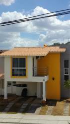 Living and dining room with sliding doors leading to terrace in modern house Vista Alegre Arraiján Panama