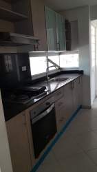 Kitchen with upper-lower cabinetry, black countertop and stove Vista Alegre Arraiján