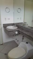 Stylish bathroom with granite counter, vessel sink and mirror in Arraiján house