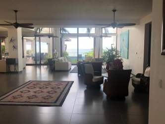 Spacious living room in luxury beachfront mansion with large windows facing the Pacific Ocean Coronado Panama