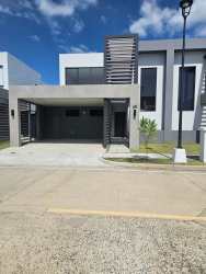 Bright modern living room with neutral decor, large windows, and contemporary design Casa Explora Panama Pacifico