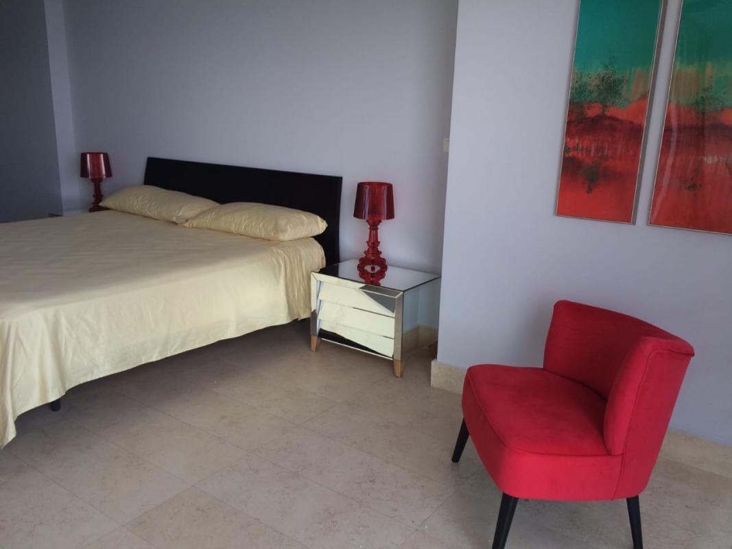 Contemporary bedroom with ocean view at PH YOO Panama, modern furniture and decor