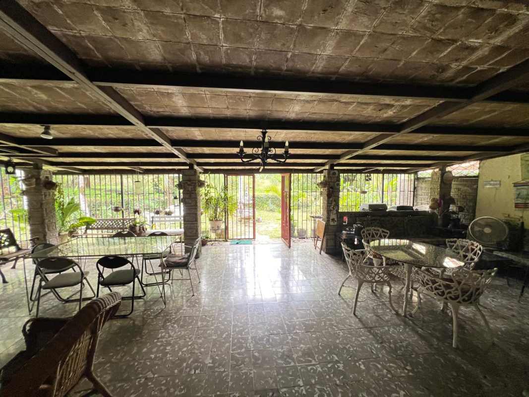 Rustic patio with beams, natural stone, wrought iron and garden surroundings in Las Cumbres